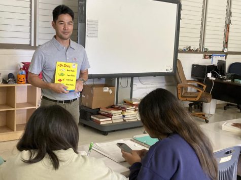 Marcus Nakama uses a Dr. Seuss book to illustrate points in his class.