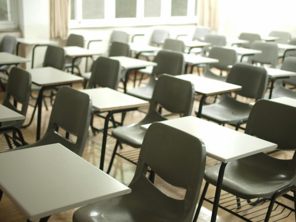 An empty classroom, illustrating rising concerns of attendance. Photo Credit: MChe Lee on Unsplash.