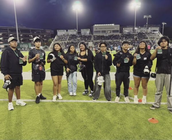 Saber Photography Club members covering the Open Division Football State Championship game at UH Mānoa.